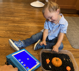 Gus sitting on the floor with his device